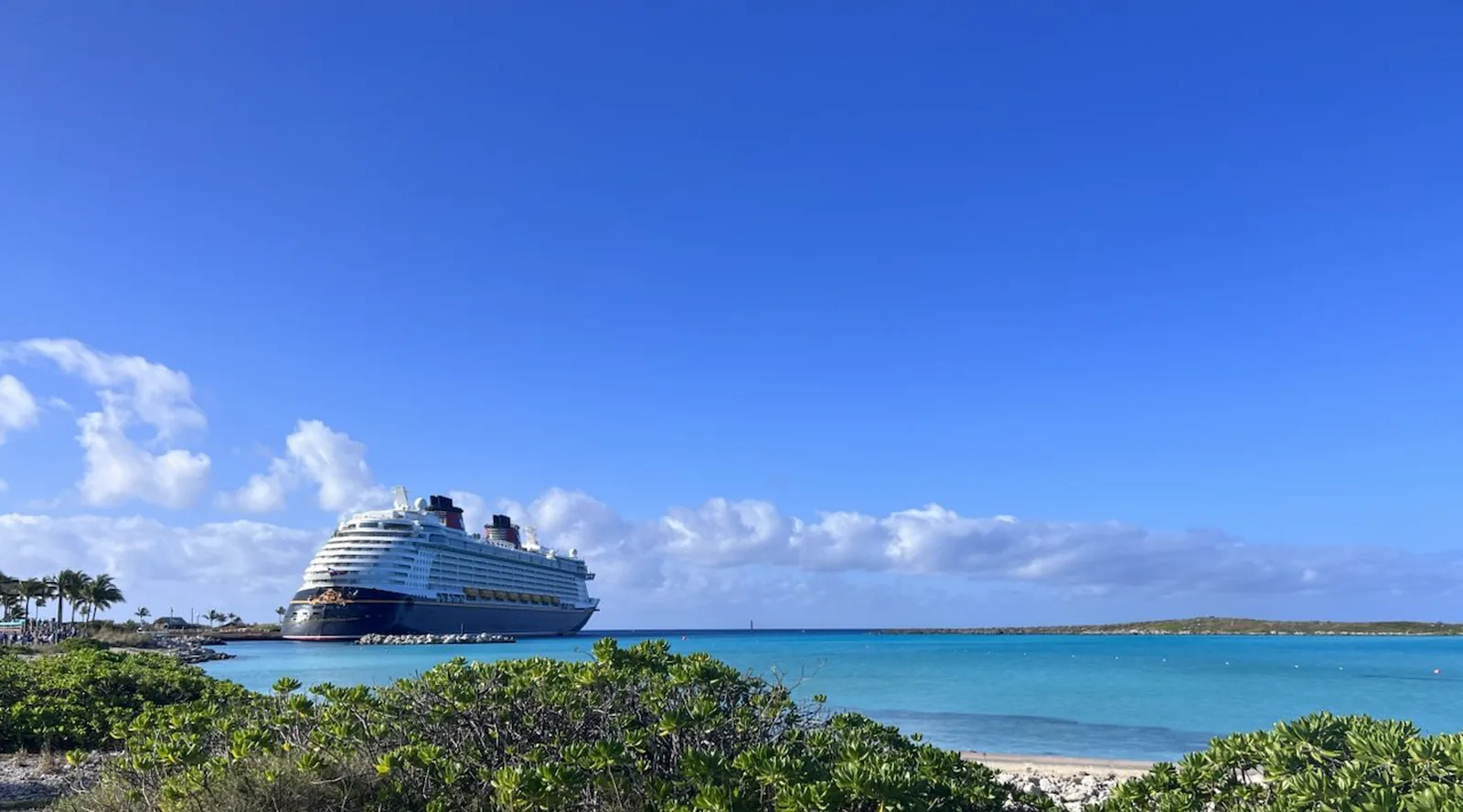 Cruise ship docked beside turquoise water