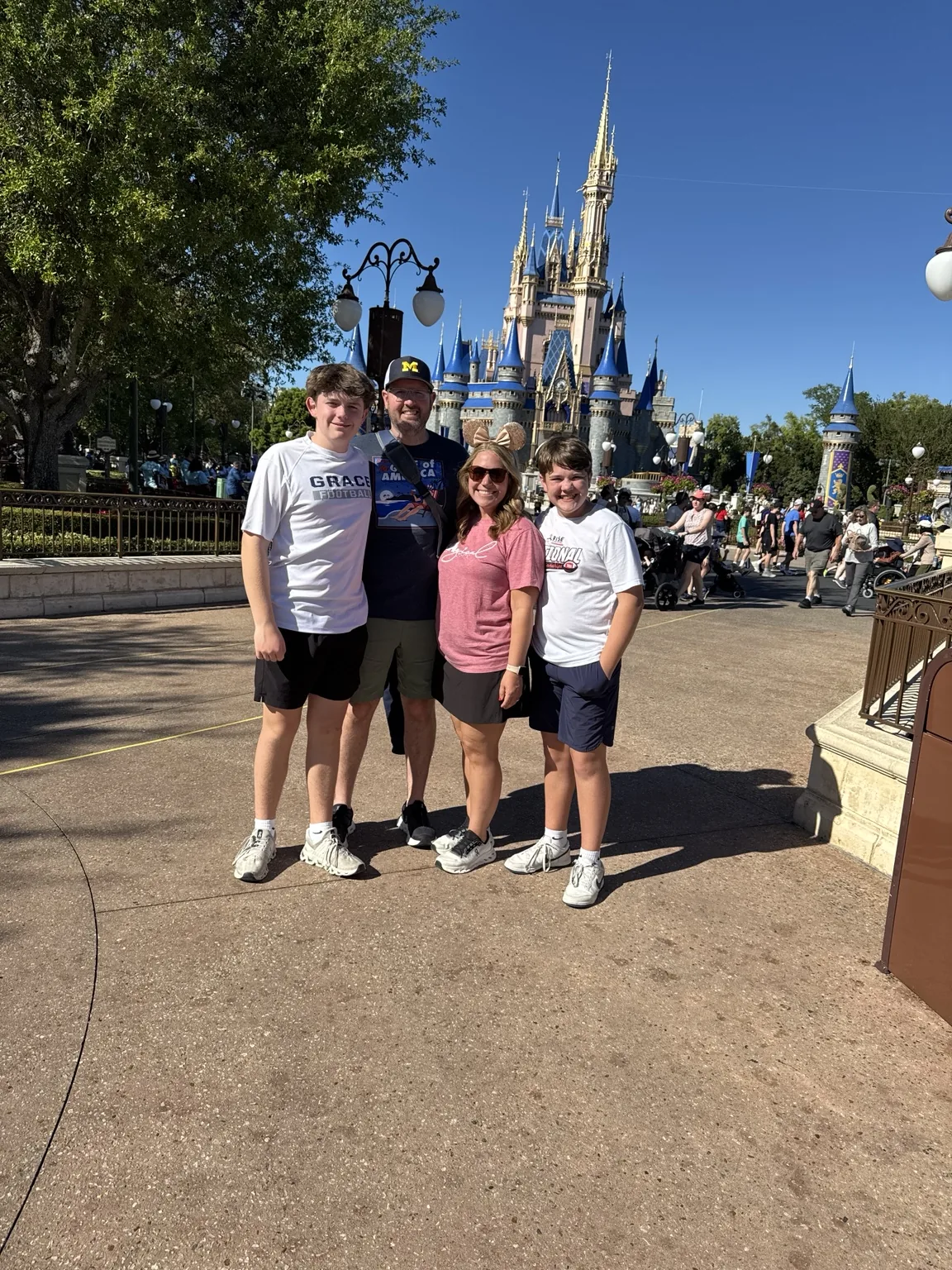 Amber with family in front of Disney castle